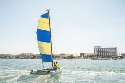 a man riding on the back of a boat in a body of water